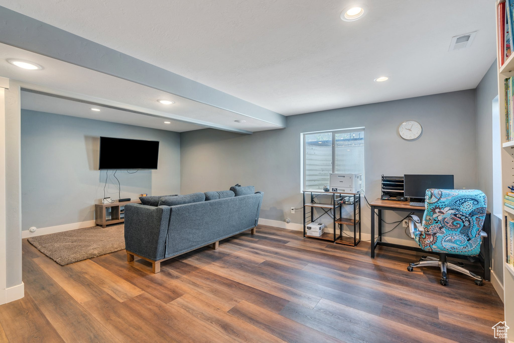 Living area with wood finished floors, a desk, recessed lighting, and healthy amount of natural light