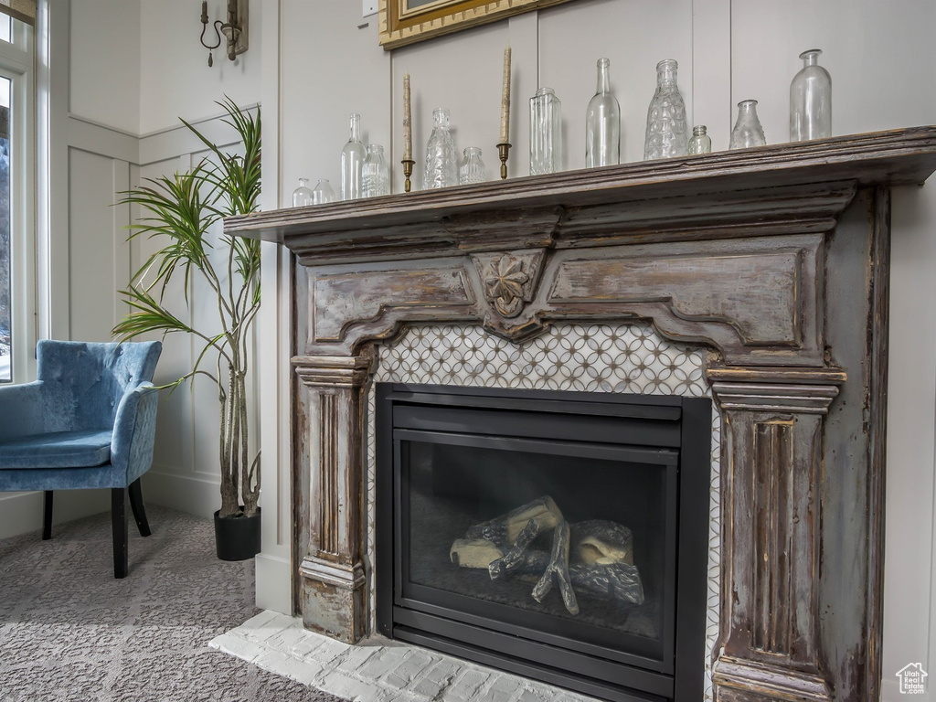 Detailed view of a tile fireplace and carpet