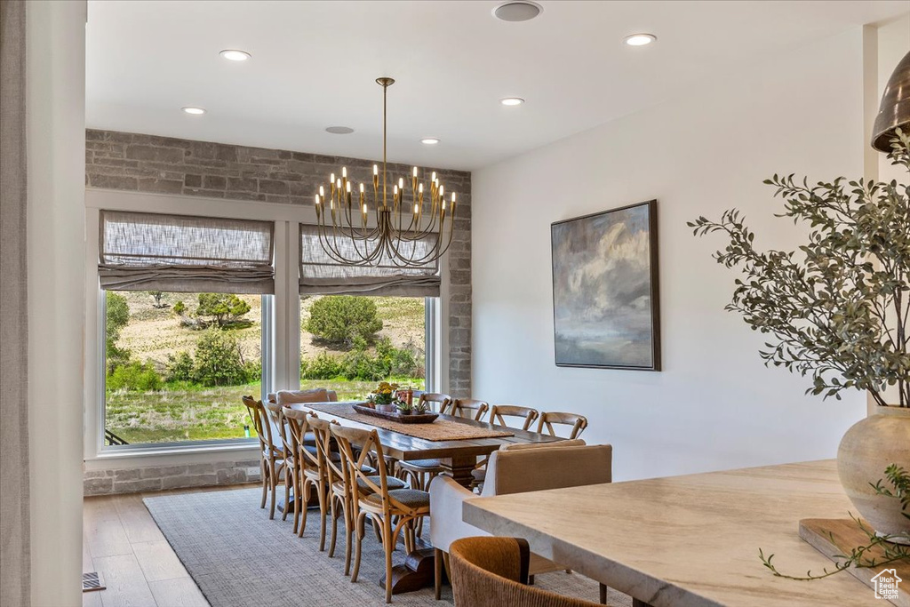 Dining space featuring a chandelier, recessed lighting, and wood finished floors