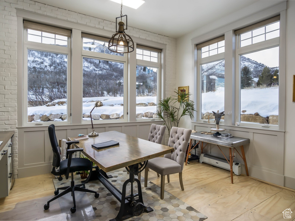 Office with light wood-style floors, a baseboard heating unit, and a mountain view