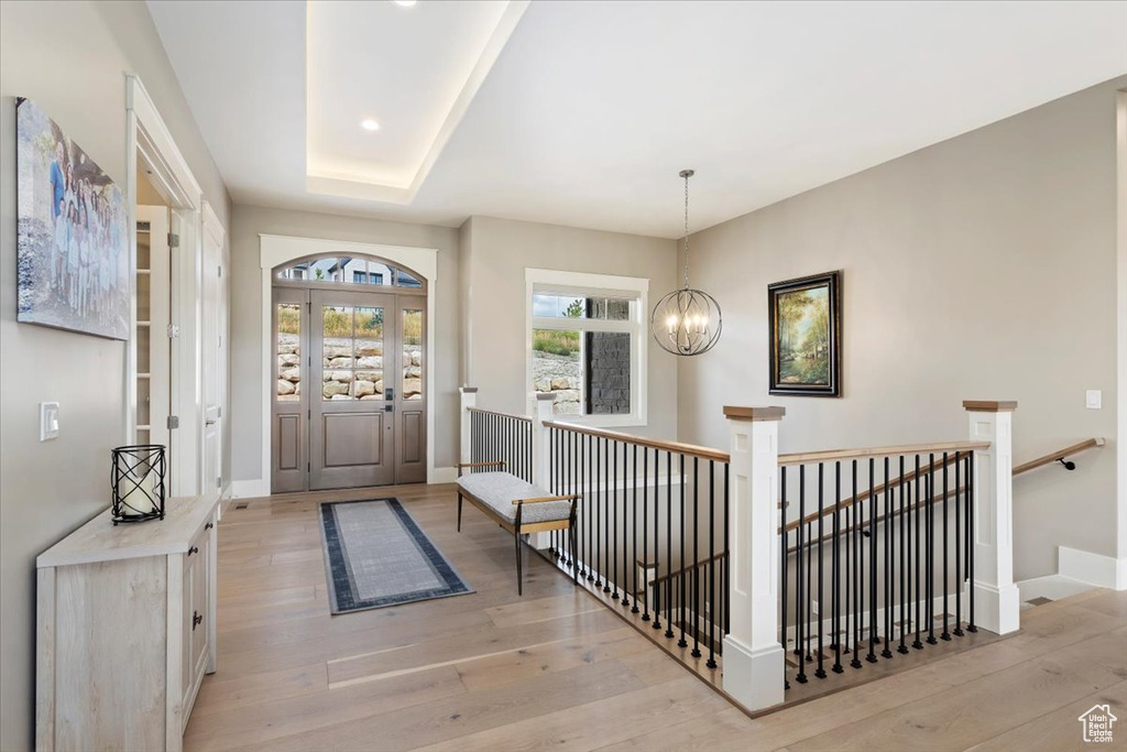 Entrance foyer with a chandelier, light wood-type flooring, and recessed lighting