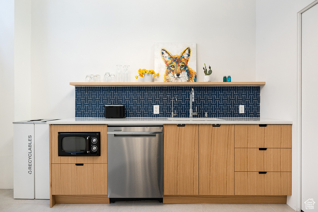 Kitchen featuring stainless steel dishwasher, black microwave, open shelves, and light countertops
