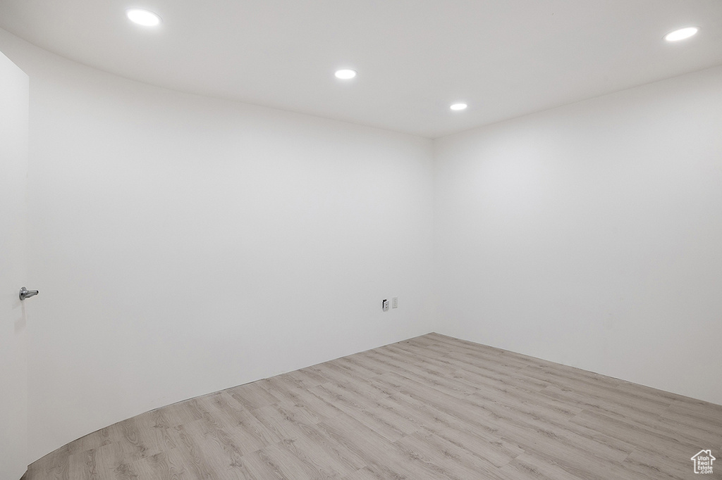 Empty room with recessed lighting and wood finished floors