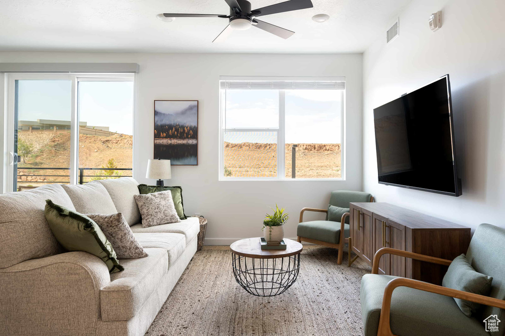 Living area featuring ceiling fan and wood finished floors
