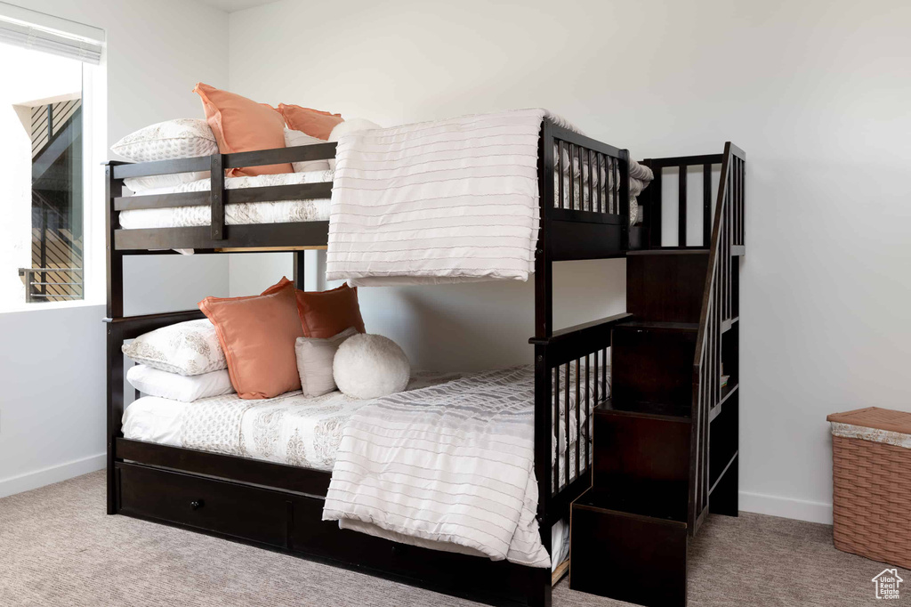 Carpeted bedroom featuring baseboards