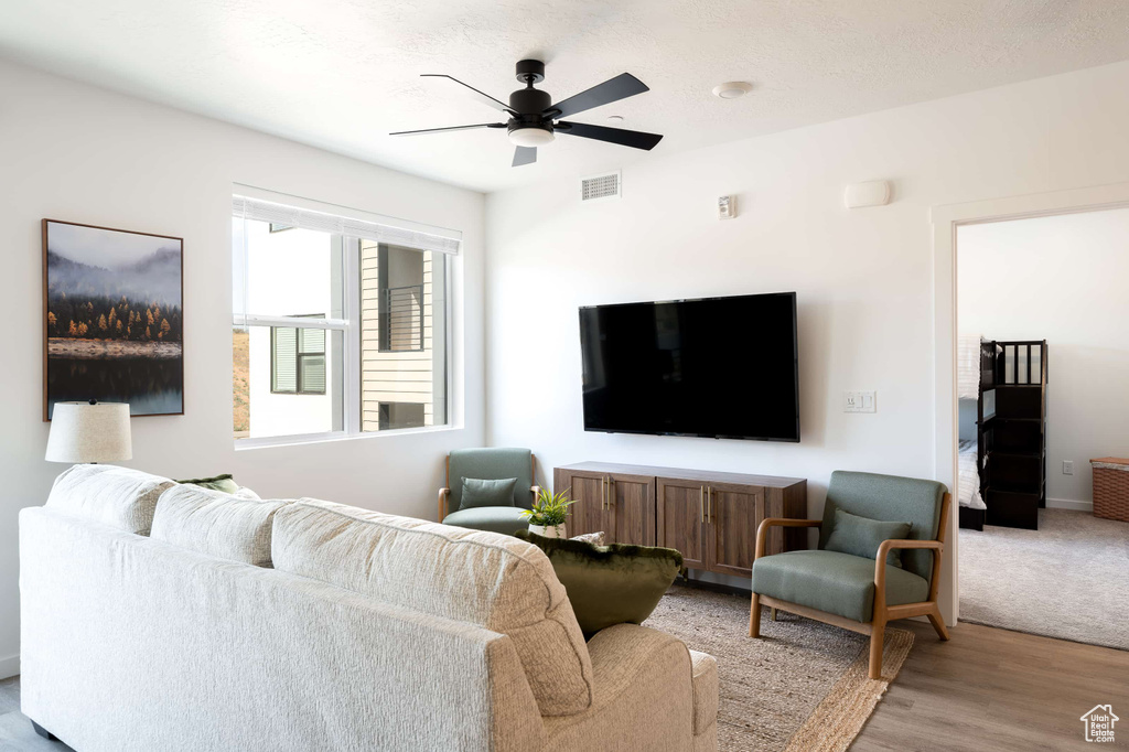 Living room with a ceiling fan and wood finished floors
