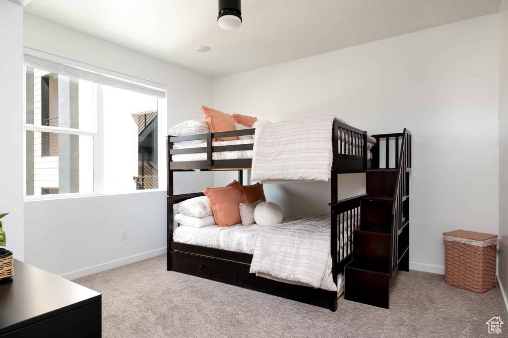 Bedroom featuring carpet floors and baseboards