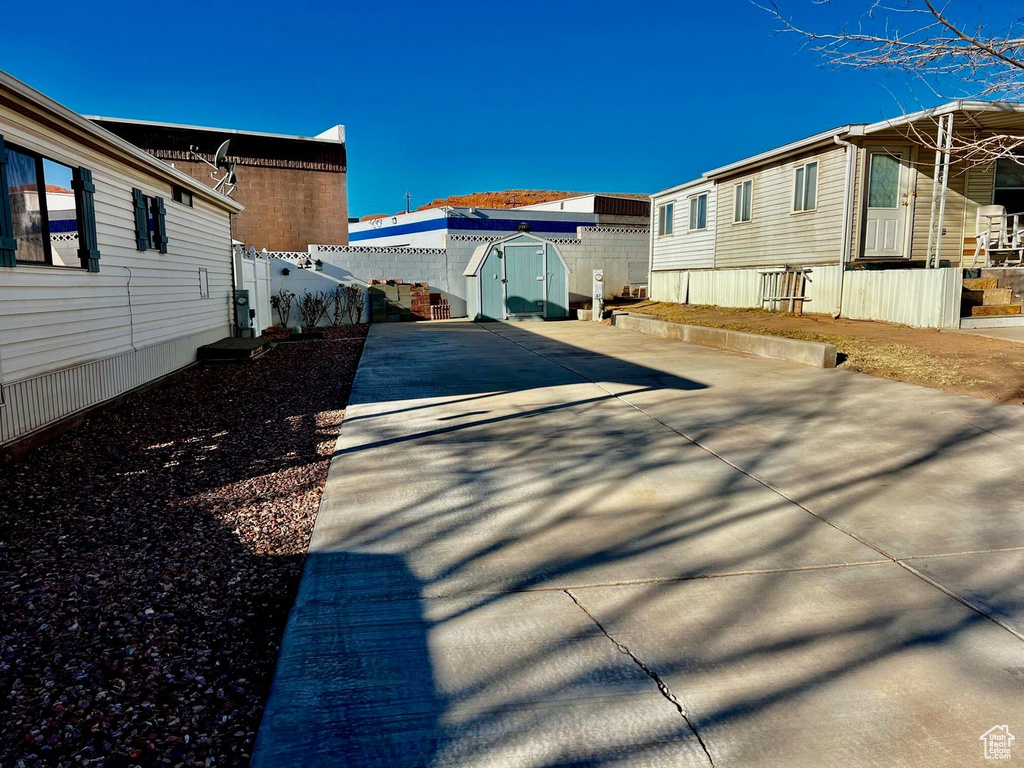 View of home's exterior with a storage shed and driveway