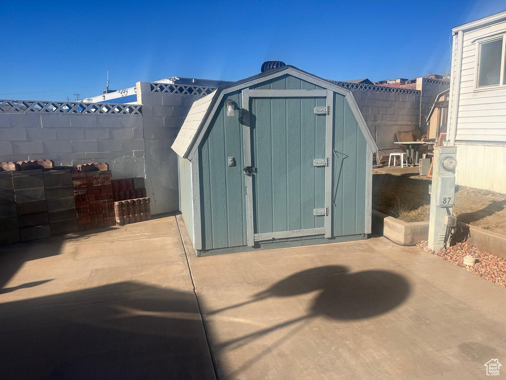 View of shed with a fenced backyard
