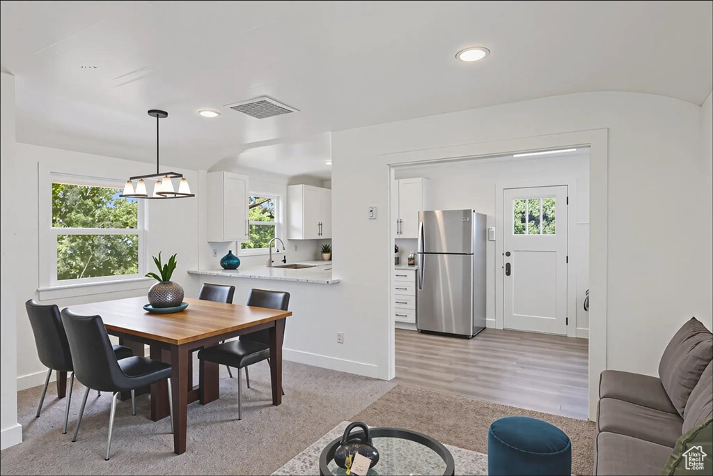 Dining space featuring recessed lighting and a chandelier