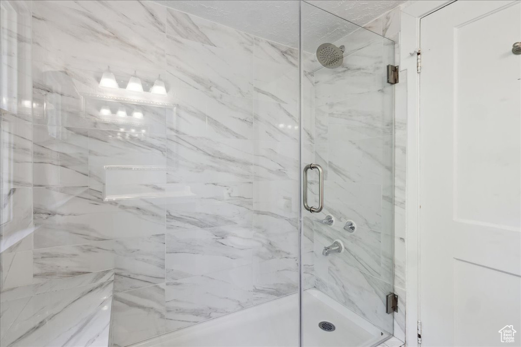 Bathroom featuring a marble finish shower