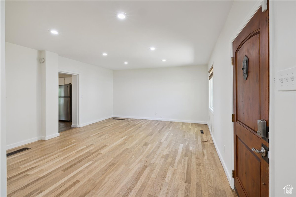 Spare room with light wood-style floors and recessed lighting