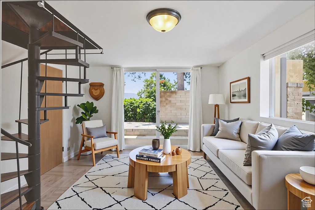 Living area with stairway and baseboards