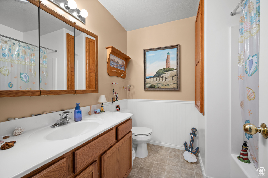 Full bath with vanity and wainscoting