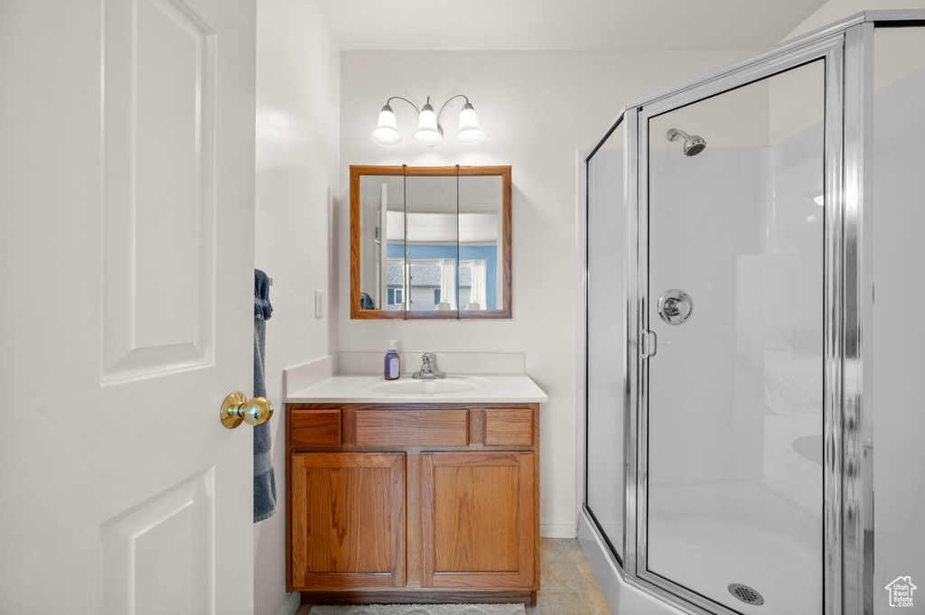 Bathroom featuring a shower stall, vanity, and tile patterned floors