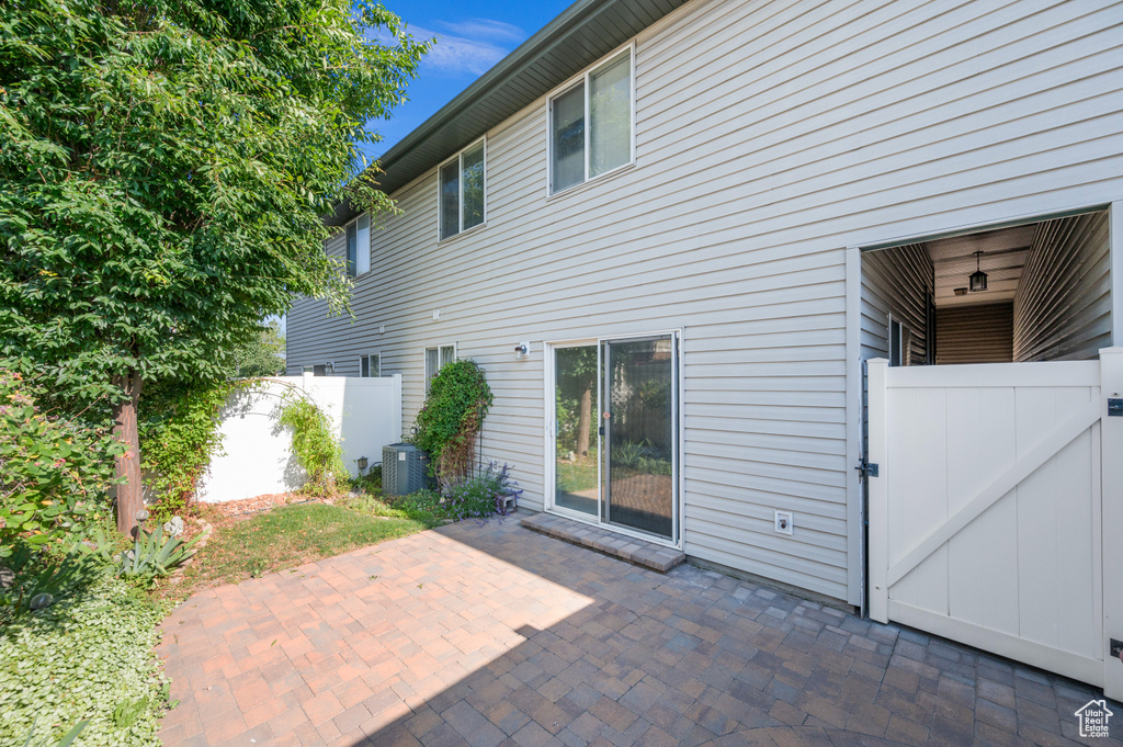 Rear view of property featuring a gate and a patio area