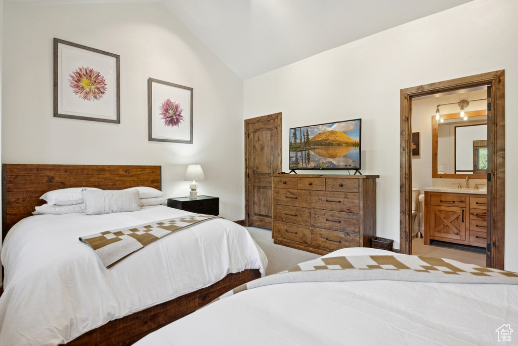 Carpeted bedroom with vaulted ceiling and ensuite bathroom