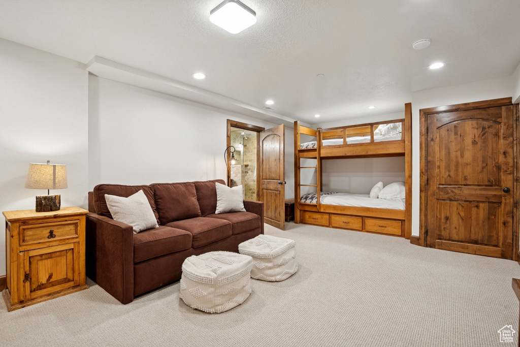 Living area featuring light carpet and recessed lighting