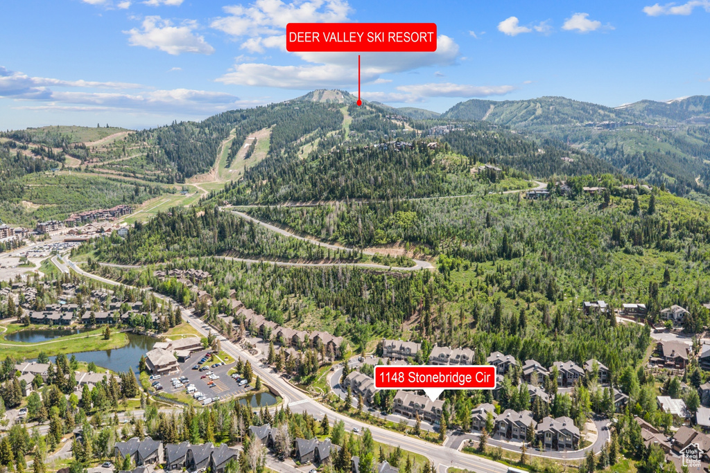 View of property location with a forest and a water and mountain view