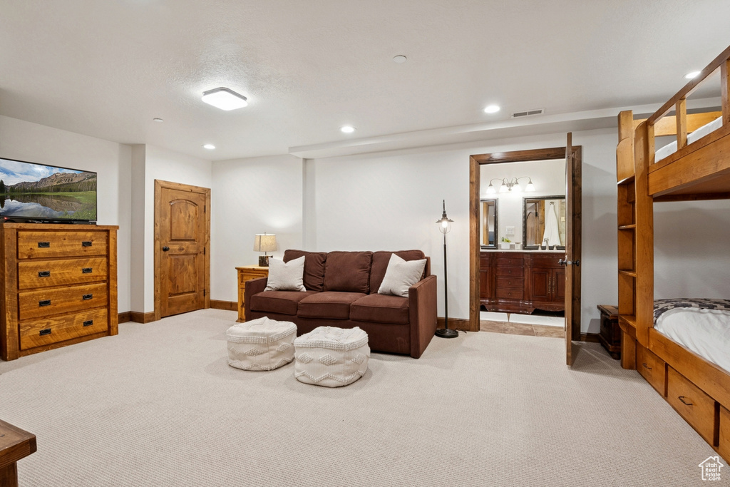 Living area featuring light carpet and recessed lighting