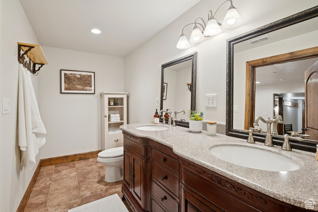 Bathroom featuring double vanity and recessed lighting