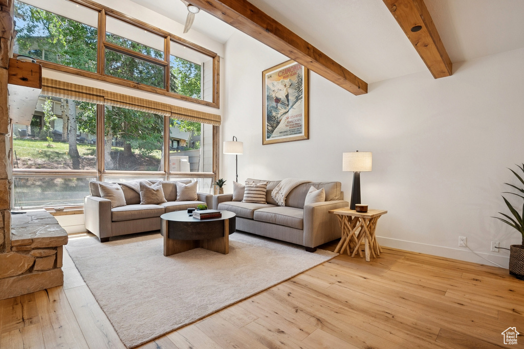 Living room with beamed ceiling and wood-type flooring