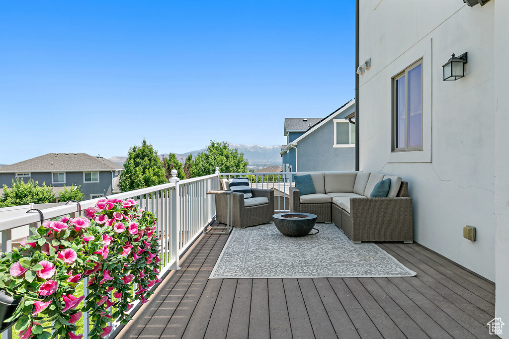 Deck with an outdoor hangout area and a mountain view