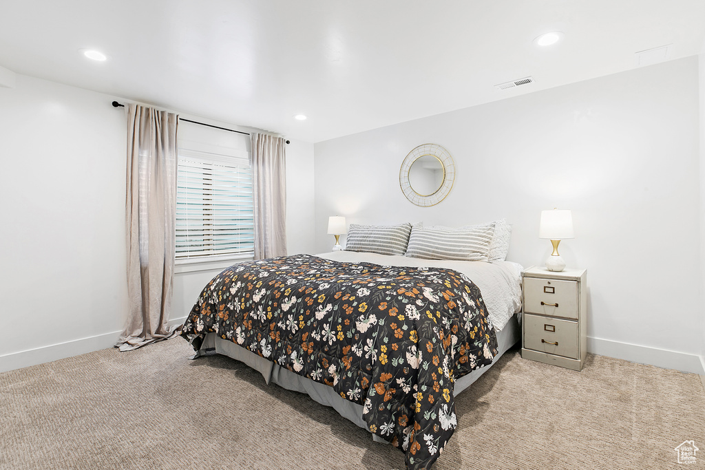 Carpeted bedroom with recessed lighting