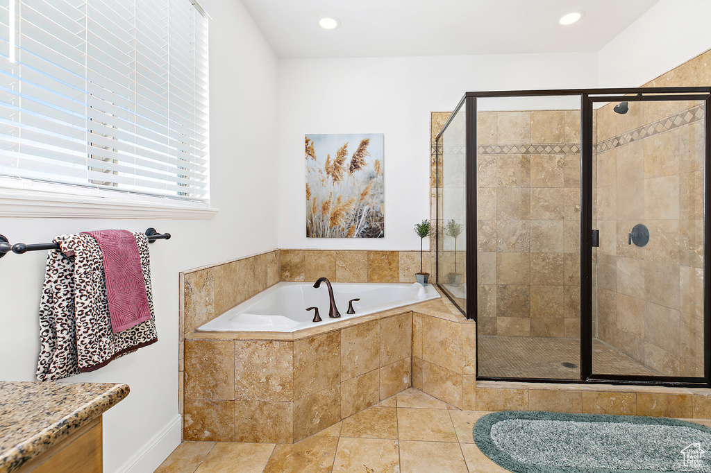Bathroom featuring a bath, a stall shower, recessed lighting, and tile patterned floors