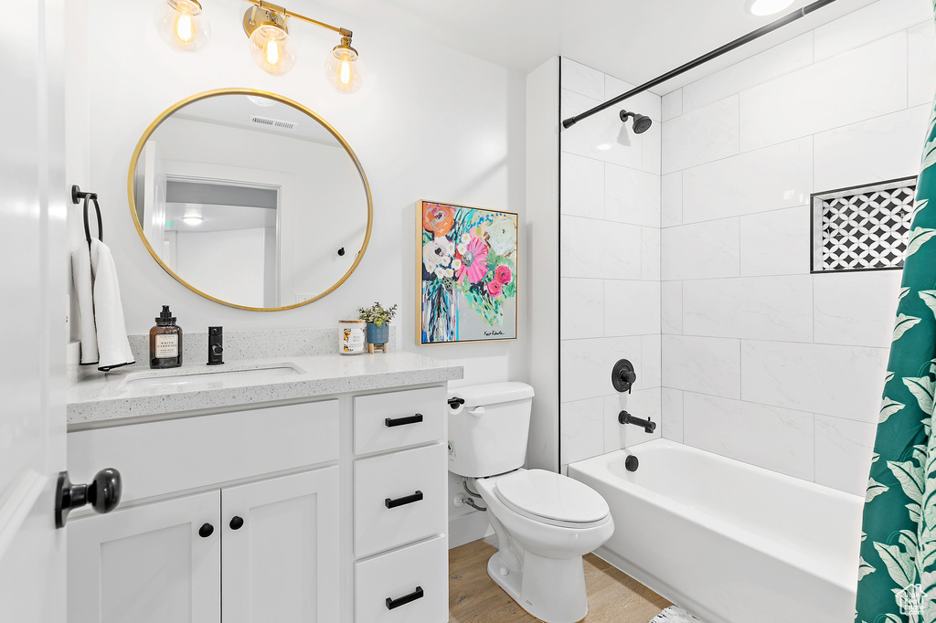 Full bath with vanity, shower / bathtub combination with curtain, and wood finished floors