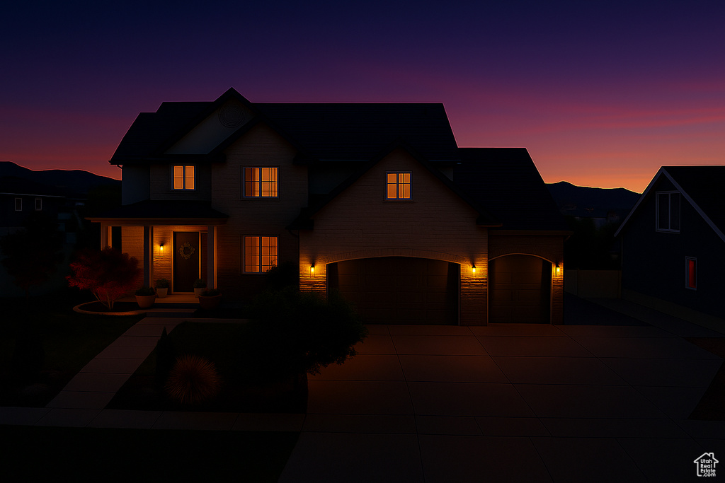 Traditional-style house featuring an attached garage and concrete driveway