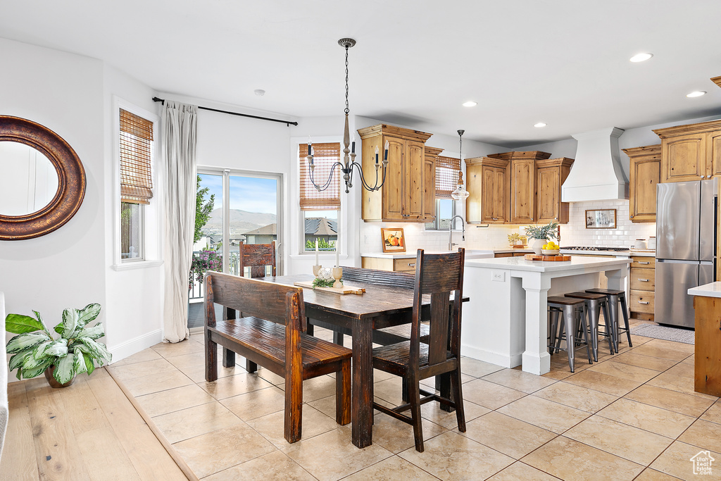 Dining space with recessed lighting and baseboards
