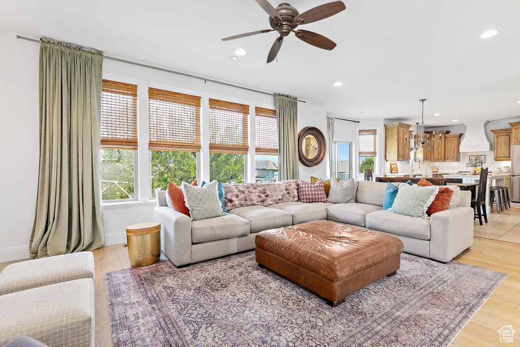 Living room featuring recessed lighting, a ceiling fan, and light wood finished floors