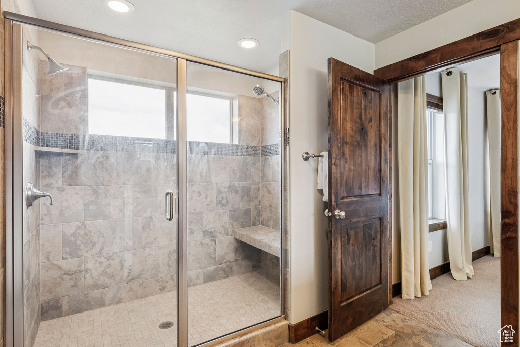 Full bathroom featuring healthy amount of natural light, a shower stall, and recessed lighting