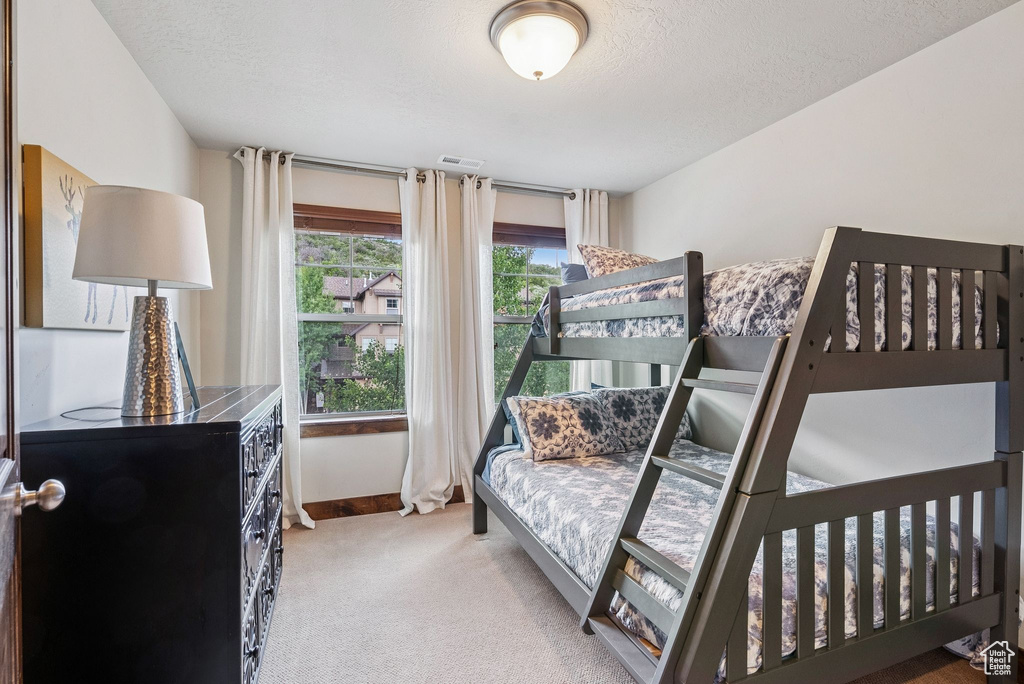 Bedroom with carpet floors and a textured ceiling