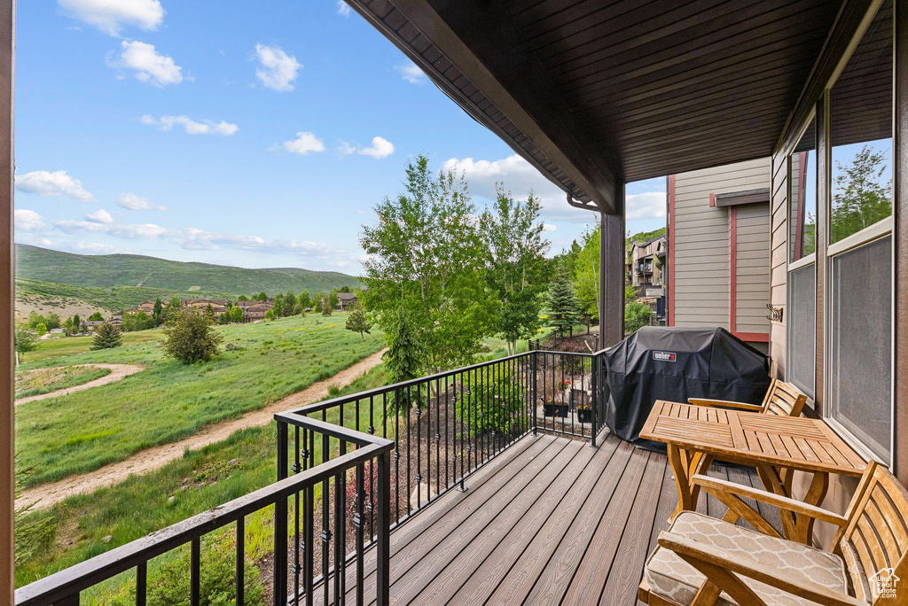 Balcony featuring a mountain view and area for grilling