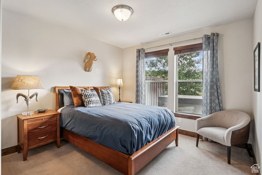 Carpeted bedroom with baseboards