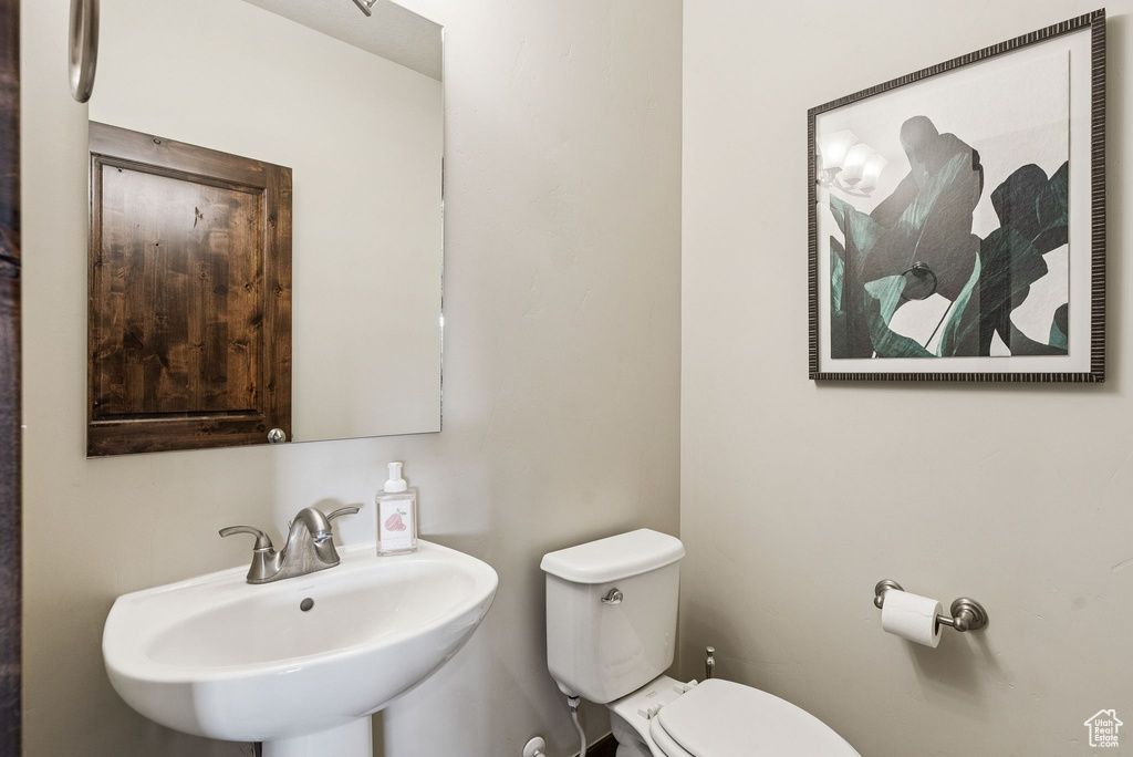 Half bathroom with a sink and toilet