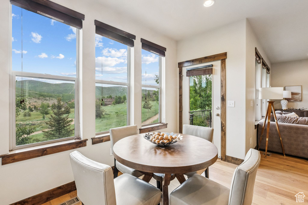 Dining room featuring light wood finished floors, recessed lighting, and a mountain view
