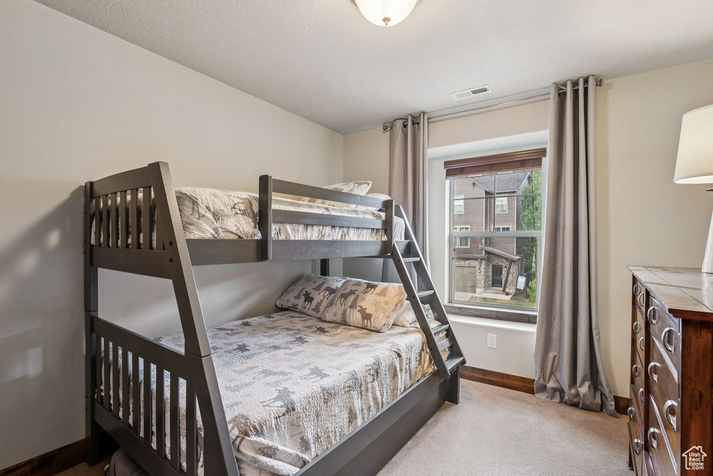 Carpeted bedroom featuring baseboards
