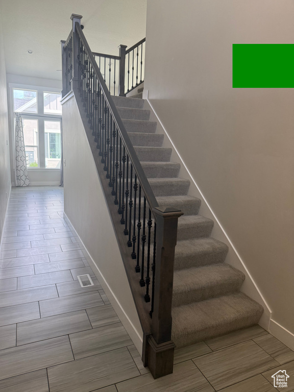Stairs featuring baseboards and wood finish floors
