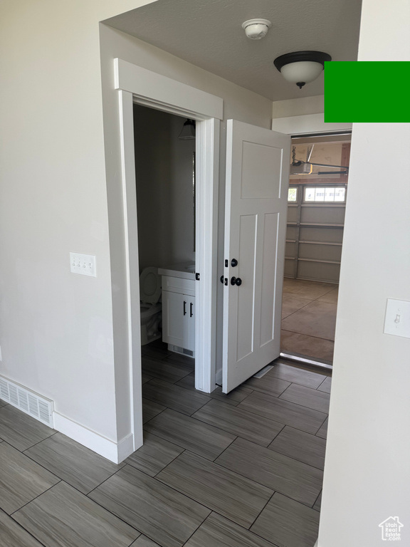 Empty room with baseboards and a smoke detector