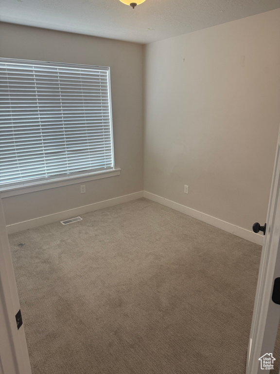 Unfurnished room with carpet floors