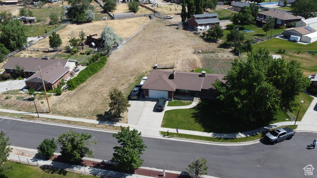 Aerial view of property and surrounding area with nearby suburban area