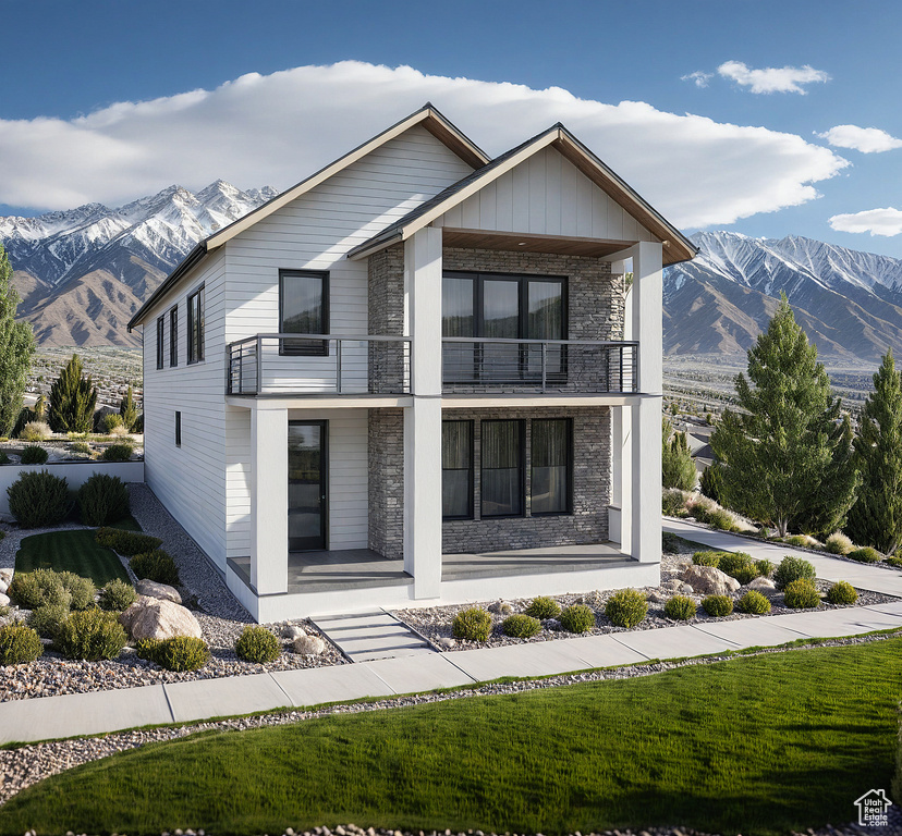 Contemporary home with a balcony, covered porch, and a mountain view