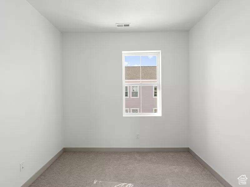 Spare room featuring carpet flooring