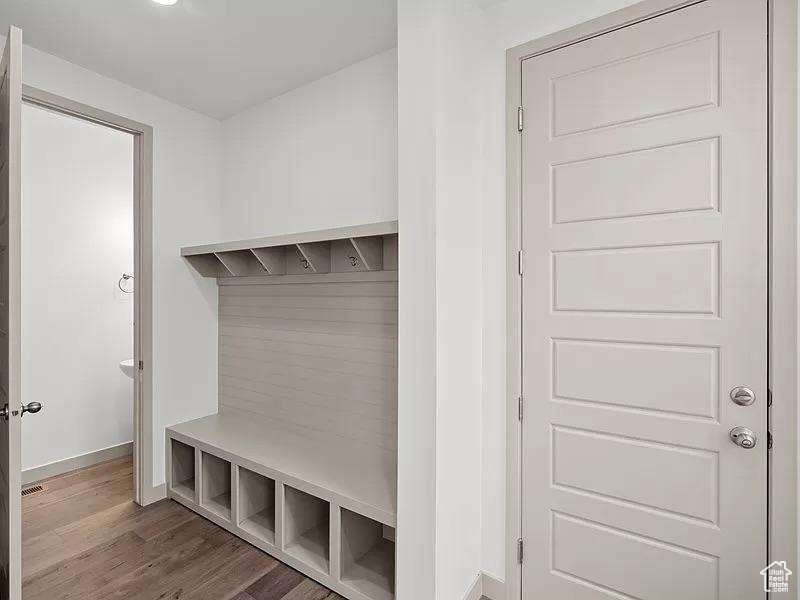 Mudroom with wood finished floors and baseboards