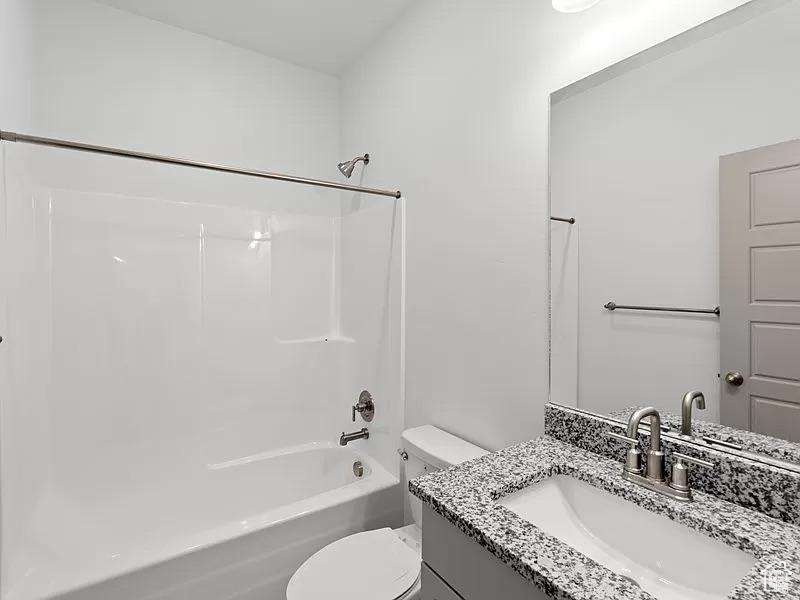 Bathroom with vanity and  shower combination