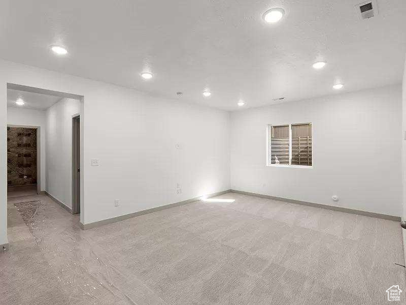 Spare room featuring baseboards and recessed lighting