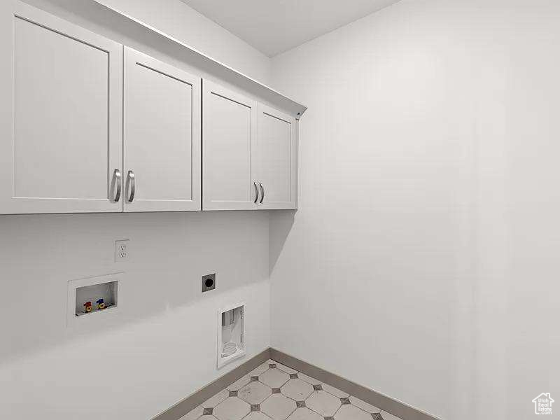 Washroom with cabinet space, hookup for an electric dryer, and washer hookup